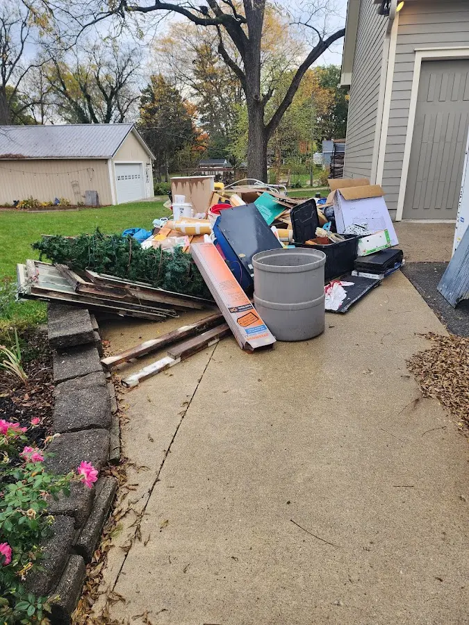 Dumpster being loaded with debris for Roofing Dumpster Rental in Pepperell